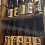 163257102 - カウンター目の前にはオリジナル日本酒「五郎」が大量にディスプレイされており、有名人（ミュージシャン系）のサインが沢山見えます。