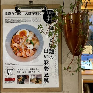 h Futatsubo Shokudou - 「本日のどんぶりご飯」と「 席 」の案内の表示ボード
          二坪食堂さんの飲み物や食べ物を飲食できる席は、
          カウンター（施設内・外）と、1階ベンチ・2階丸テーブル。