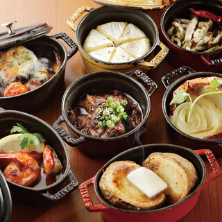 "staub" dishes with a variety of flavors served with baguette