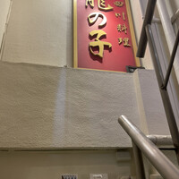 四川料理 龍の子 - 開店前から並んだお店のドア前から見上げた階段。
                    シーサーも不思議と馴染んでます。