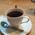 クルミドコーヒー - ドリンク写真:クルミドコーヒー。カップの後ろの小さなマトリョーシカは会計の際に持って行きます。