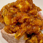 f - 旬の蕗の薹とトマトソースに栄螺がゴロゴロとたくさん入って豚肉の上に乗っています