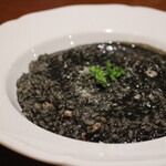 Squid ink risotto slowly stewed with organic vegetables