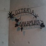 オステリア・ナカムラ - 入り口横の店名サインです。