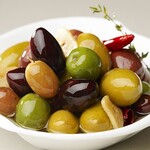 Assortment of 4 colors of marinated olives with herbs