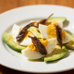 Appetizer of avocado, anchovies and boiled egg