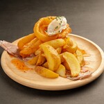 Onion rings and fries with sour cream sauce