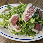 Salad with arugula selvachico, sprouts and Prosciutto