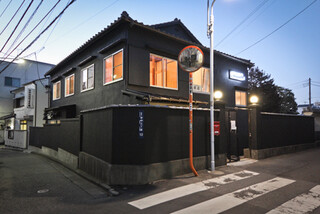 HAGI CAFE  - 真っ黒な外観にネオンサインが光る一軒家です。