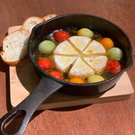 Ajillo with whole camembert and colorful tomatoes