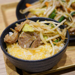 Takatano Gohan - 卵ご飯にホルモン野菜炒めを乗せて食べる♪