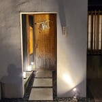 馳走 啐啄一十  - 店舗外観
      落ち着いた雰囲気
      槍鉋で削り出された扉がライトに照らされ陰影を浮かび上がらせています