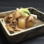 Simmering beef tendon stew with daikon radish