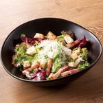 Caesar salad with colorful vegetables and grilled bacon