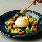 Creamy Italian burrata and seasonal fruit caprese