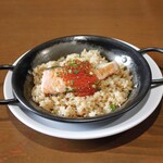 Salmon and salmon roe on iron plate with garlic rice