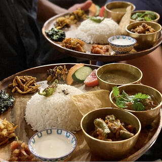 A variety of home-cooked dishes prepared by an authentic Nepali female chef