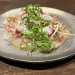 Red sea bream carpaccio with red onion and herb sambal mata