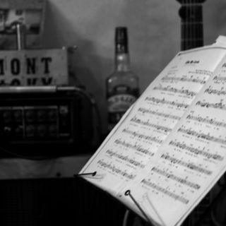 Musical instruments such as guitars, wood basses, and pianos are displayed throughout the store.