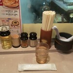 春木屋 - 提供される水とおしぼり。本日の花と調味料等(R4.12.28撮影)
