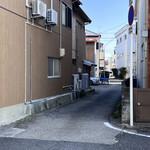 料理 萬口 - 店舗裏駐車場への道路