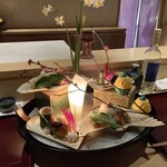銀座 しのはら - 祝い八寸：セリと雉のお浸し、鰤の藁焼き燻し、なまこの茶ぶりの霙酢、干し数の子、玉子真丈、松風、梅人参、のし梅の結び型、黒豆、せんまい漬け、蛸の炊いたん、スモークサーモンの黄身酢がけ、鰆の西京焼き、叩き牛蒡
