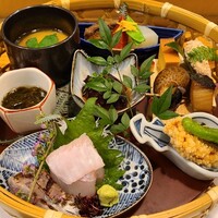 喜心 - 特選籠御膳
                ①胡麻豆腐、雲丹載せ②鮃と炙り真鯵③帆立のおかき揚げ④岩もずく酢⑤真蛸の軟らか煮⑥炭火焼き寒鰆⑦バイ貝⑧厚焼き玉子⑨助宋鱈の真子⑩茶碗蒸し⑪寒鰤幽庵焼き、金時人参、大根の焚き合わせ