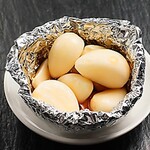 Grilled garlic in foil, salt and butter