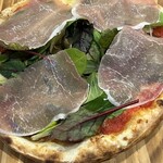 Prosciutto and baby leaf pizza