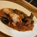 Octopus and olives stew in spicy tomatoes