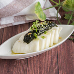 Mozzarella cheese topped with raw seaweed