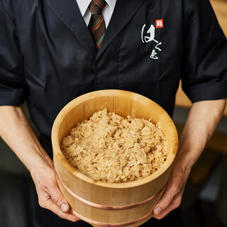 A Sushi with 50 years of experience as a sushi chef shows off his skills.