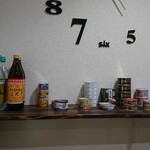 菊マル - ドリンク写真:店内 棚 むぎ焼酎・缶詰