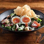 Caesar salad with soft-boiled eggs and crispy bacon