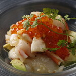 Shrimp, scallop, and avocado tartare topped with salmon roe