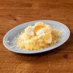 Potato salad with soft-boiled egg topped with mimolette