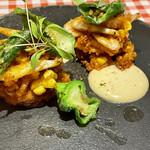 料理店 吉田 - とうもろこしと白海老のカリッと香ばしいかき揚げ。ぴりっとスパイシーな味付け！ベビーパクチーものって、エスニックな雰囲気。アンチョビ入りのアーリオオーリオがよく合う！