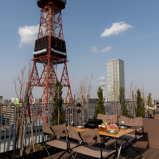 Authentic Genghis Khan (Mutton grilled on a hot plate) with Sapporo TV Tower in front of you