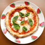 Pizza with melted mozzarella cheese and freshly picked basil