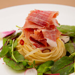 Seasonal vegetable pepenoncino topped with raw Prosciutto cut from logs