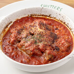 Sliced pork stewed in soft tomato sauce