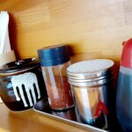 ラーメン 盛太郎 - カウンターに載るアイテムたち。箸立てのとなりにある黒いツボは「お残し厳禁アイテム」です！私は投入分、しっかり食べ切りますぞ！しばらくして....