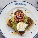 Avocado toast with serrano jamon and figs, roasted almonds and poached eggs