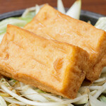 A single piece of deep-fried tofu cooked with oden stock