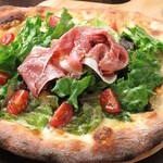 生火腿和新鮮蔬菜的披薩
