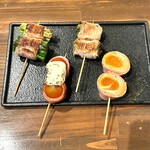 Assortment of 4 types of veggie pork skewers