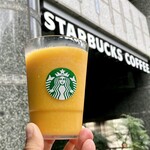 スターバックス・コーヒー - お店看板を背にした「マンゴー パッションティー フラペチーノⓇ」