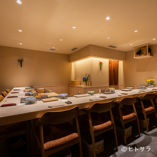 The luxurious interior is crowded with people enjoying Sushi on special occasions.