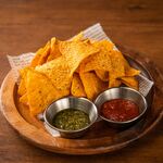 Tortilla chips with basil and tomato sauce