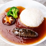 Rice topped with whole sea cucumber